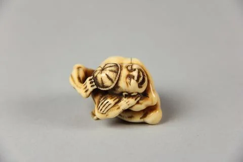 Netsuke of Acrobat Removing his Hat with His Foot 19th century Japan. Netsu.. Stock Photos