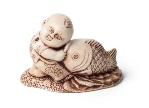 Netsuke of the boy with big fish. Isolated Stock Photos