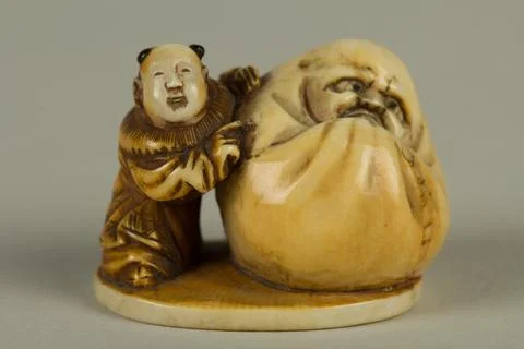 Netsuke of Dharma with a Small Boy 19th century Japan. Netsuke of Dharma wi.. Stock Photos