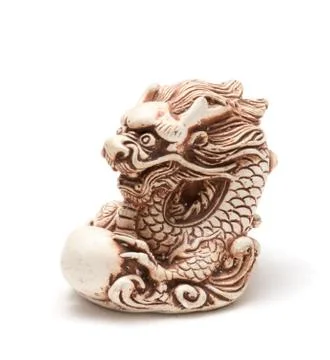 Netsuke of east dragon, which guarding the egg. Isolated Stock Photos