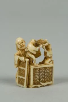 Netsuke of Man Training Birds 19th century Japan. Netsuke of Man Training B.. Stock Photos
