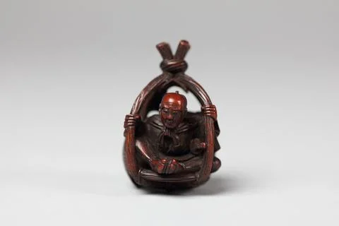 Netsuke of Old Man in a Basket 19th century Japan. Netsuke of Old Man in a .. Stock Photos