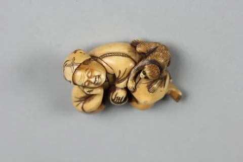 Netsuke of Sleeping Man and a Monkey 19th century Japan. Netsuke of Sleepin.. Stock Photos