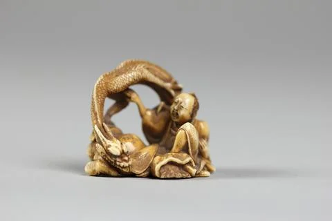 Netsuke of Two Figures and a Dragon 19th century Japan. Netsuke of Two Figu.. Stock Photos