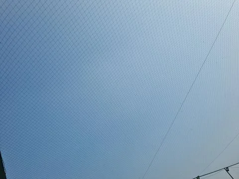 Netting pattern stretched with blue sky background Stock Photos