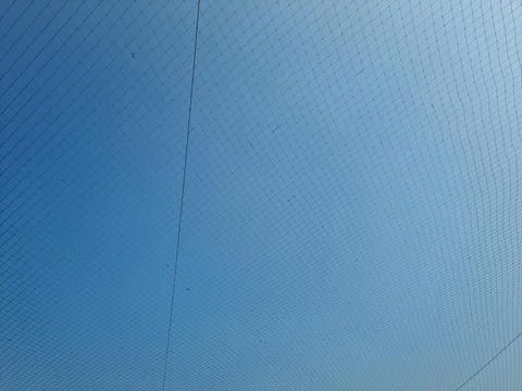 Netting pattern stretched with blue sky background Stock Photos