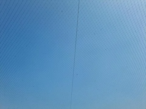 Netting pattern stretched with blue sky background Stock Photos