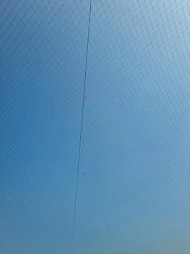 Netting pattern stretched with blue sky background Stockfoto's