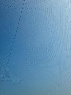 Netting pattern stretched with blue sky background Stock Photos