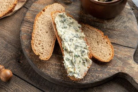 Nettle butter on a slice of bread on a table Stock Photos