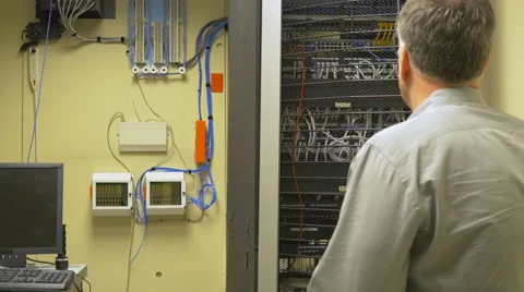 Network administrator checking patch cables in a server rack Stock Footage 50998046