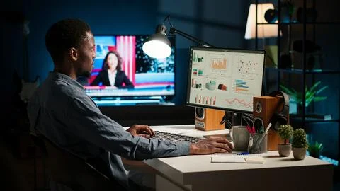 Network analyst studying digital commerce progression reports on computer Stock Photos