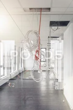 Network And Power Cables Hanging From New Office Corridor Ceiling