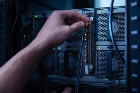 Network cable being connected to the data server Stock Photos