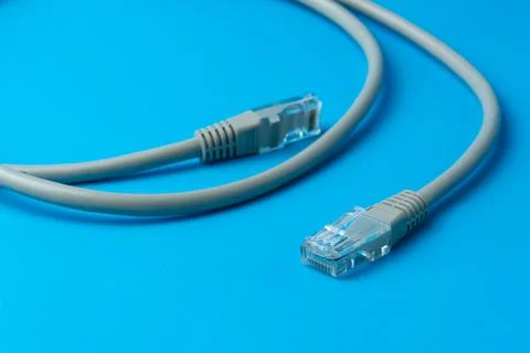 Network cable on a blue background close-up Stock Photos