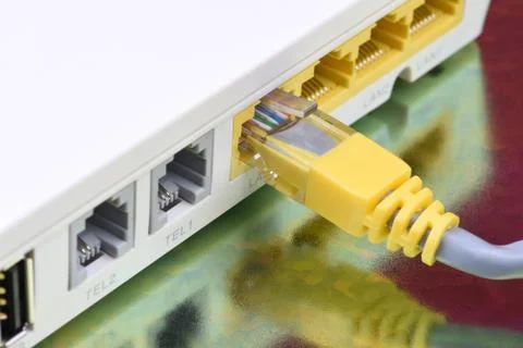 Network cable connected to internet router Stock Photos