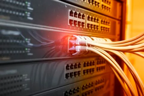 Network cable connecting on network core switch close up Stock Photos