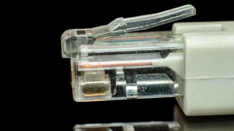 Network cable connector isolated on black background Stock Photos