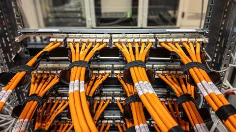 Network cables arranged neatly in a server rack in a modern data center Foto stock