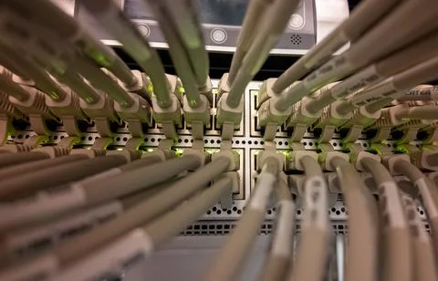 Network cables connected in a server room showcasing organized data Stock Photos