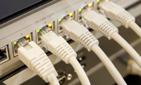 Network cables connected to switch Stock Photos