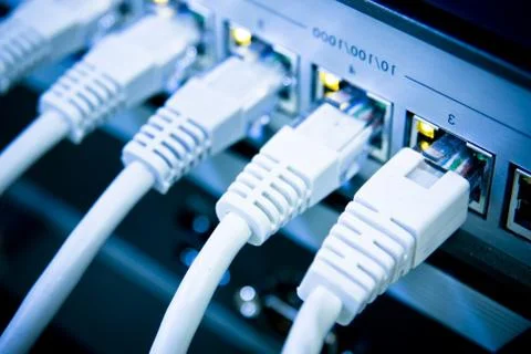 Network cables connected to switch Stock Photos