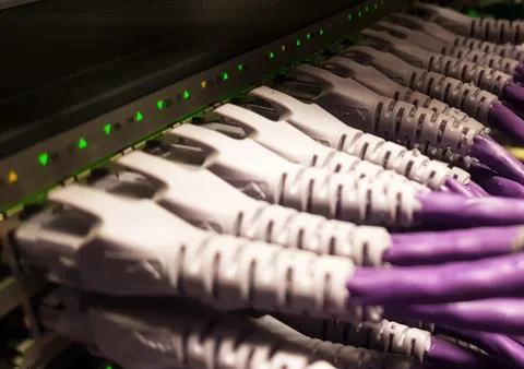 Network cables plugged in to a switch Stock Photos