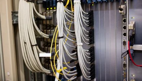 Network cabling is being shown in flat design rack with gray cables and yellow Stock Photos