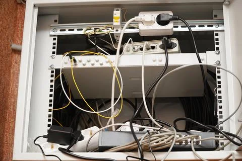 Network computer cables connected to a router or modem in office Stock Photos