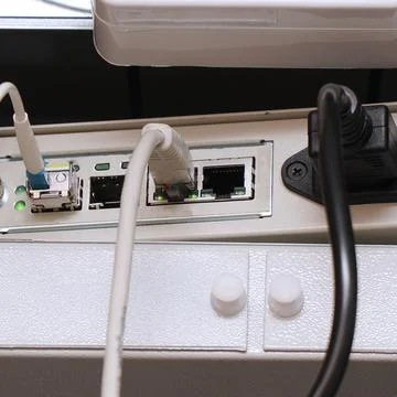 Network computer cables connected to a router or modem in office Stock Photos