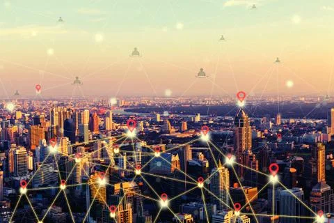 Network connection and communication concept in downtown city at sunset. Stock Photos