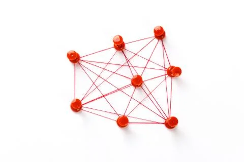 Network connection made from push pins and thread on blue background, close-u Stock Photos