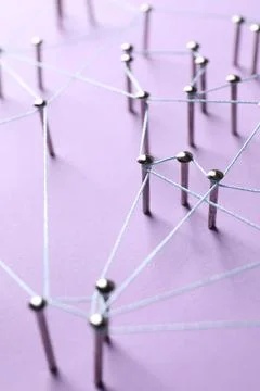 Network connection. Nails linked together by thread on violet background, c.. Stock Photos