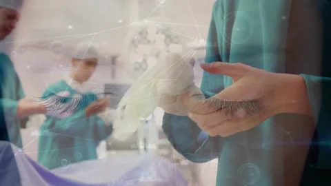 Network of connections against mid section of surgeon wearing surgical gloves at Stock Footage 326425840