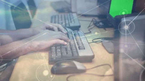 Network of connections against mid section of a person using computer at office 스톡 동영상 329412695