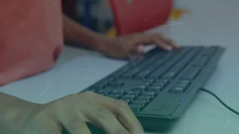 Network of connections over close up of hands typing on computer keyboard at Stock Footage 329692171