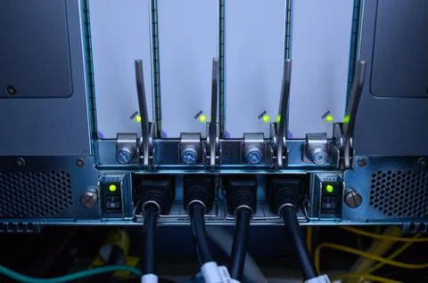 Network device back panel with power cord cables connected Stock Photos