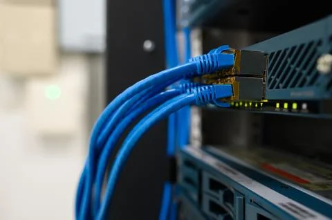 Network device front panel with utp cables connected in data center room Foto stock