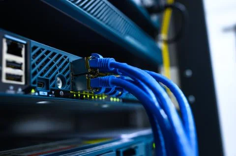 Network device front panel with utp cables connected in data center room Stock Photos