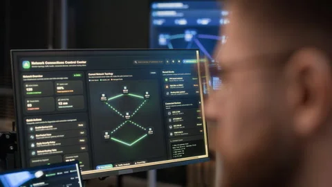 Network Engineer Analyzing Codes on Computers in Cybersecurity Office 動画素材 334928563