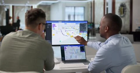 Network Engineer And Technician Collaborate On Fiber Optic Mapping Laptop. Stock Photos