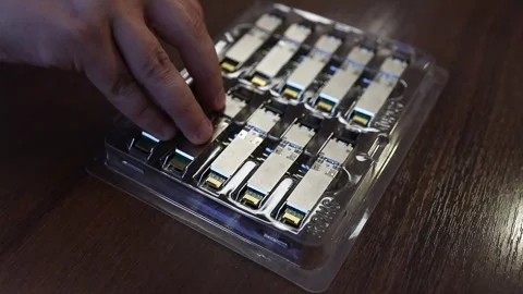 Network engineer arranging optical transceiver modules Stock Footage 282983742