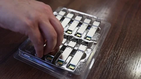 Network engineer arranging optical transceiver modules Stock Footage 282984157