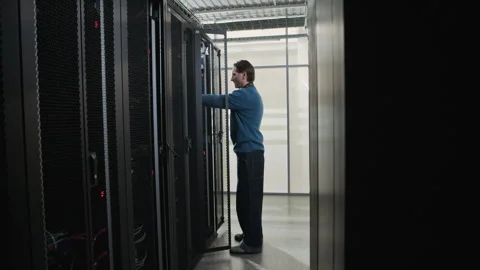 Network Engineer Connecting Cable and Installing Server in Data Center Stock Footage 330542376