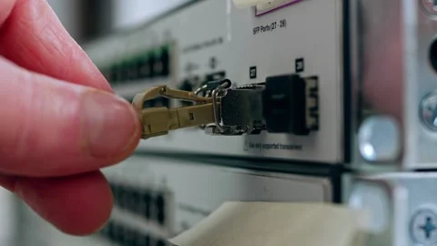 Network engineer connects fiber cable on computer switch Video stock 202035008