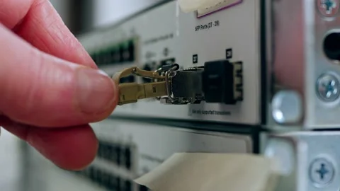 Network engineer connects fiber cable on computer switch Stock Footage 225924567