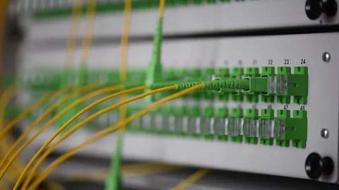 Network engineer crossing optical patch cord on distribution panel Stock Footage 86112015