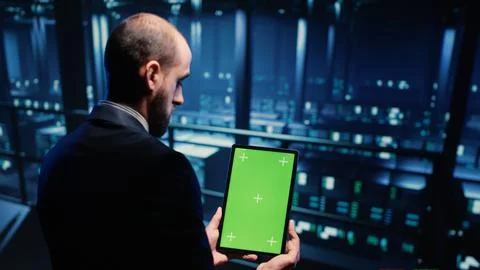Network engineer doing system check on green screen Foto stock