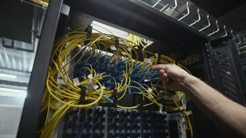 Network Engineer Hand Adjusting Ethernet Cables in Data Center Rack Stock Footage 330543603