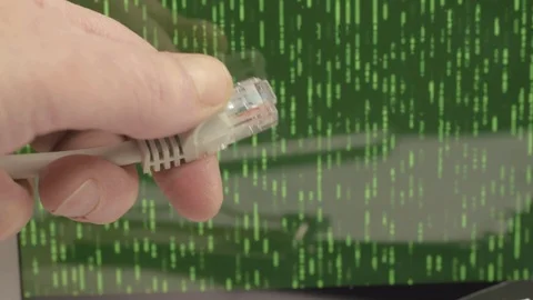 Network engineer holding Ethernet cables with green binary data output Stock Footage 126030459